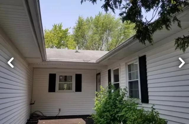 a view of a house with a tree