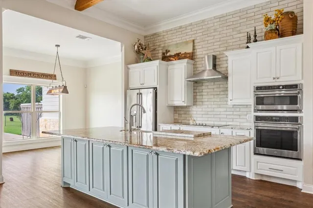 a kitchen with stainless steel appliances granite countertop a stove and a refrigerator