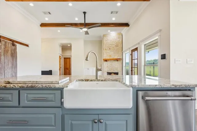 a bathroom with a granite countertop sink mirror and cabinets