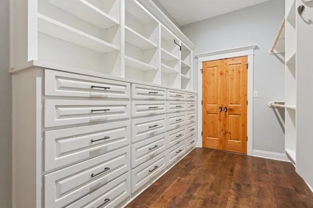 a view of walk in closet with empty racks