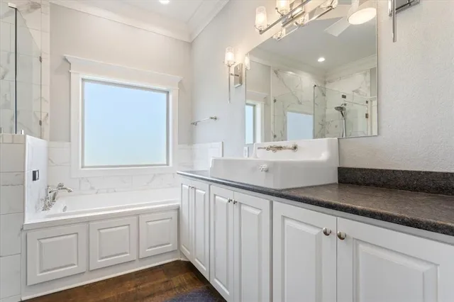 a bathroom with a sink a mirror and a shower