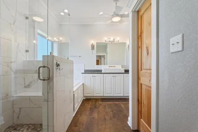 a bathroom with a shower sink and mirror