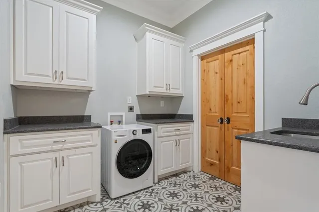 a kitchen with a stove top oven and cabinets