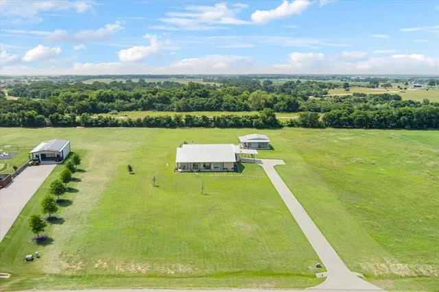 a view of a swimming pool with a yard