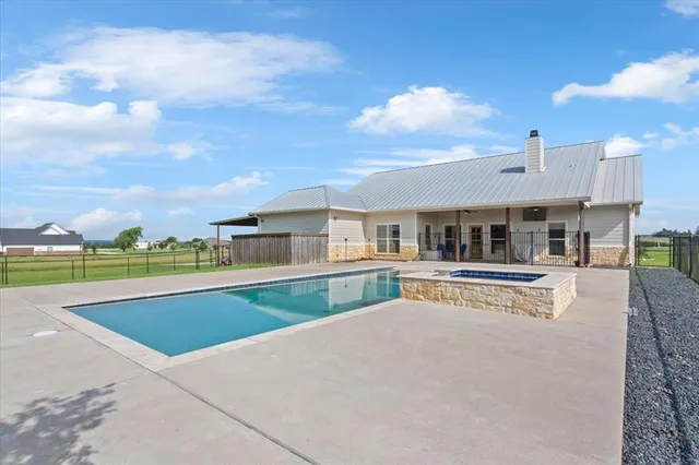 a view of a house with swimming pool and sitting area