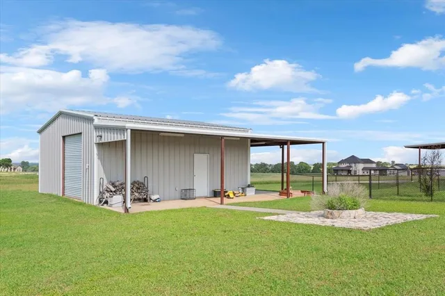 a view of a backyard with table and chairs and potted plants