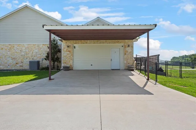 a view of a backyard with a barbeque grill and a small yard
