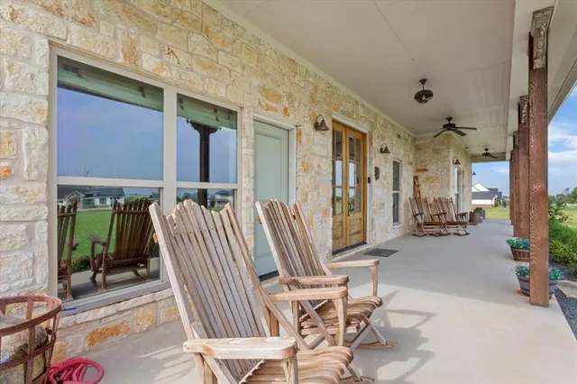 a view of two chairs in the patio