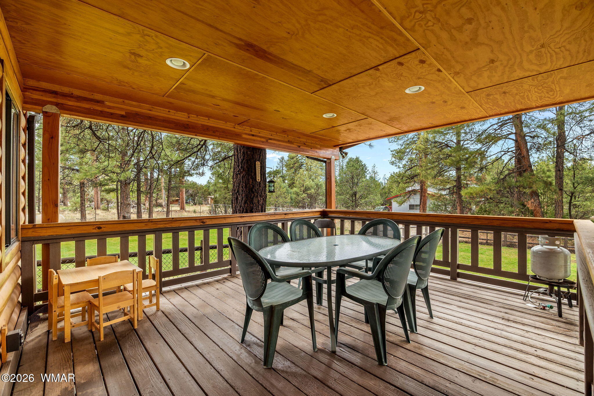 2922 Pine Rim Road Overgaard, AZ 85933 - Photo 40 of 58 a view of a balcony with wooden floor and outdoor seating