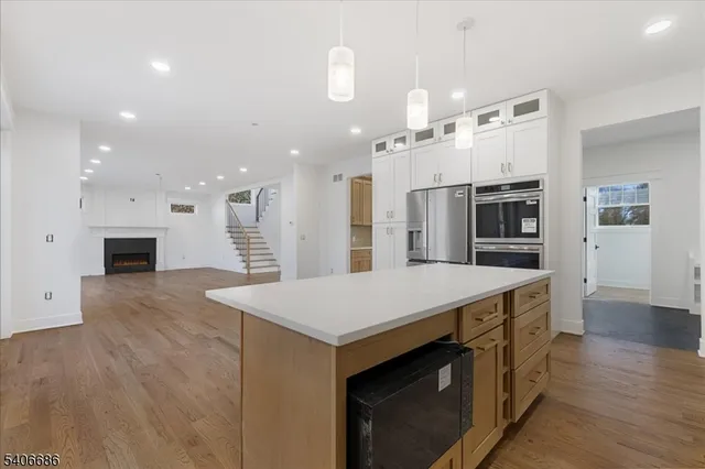 a view of staircase and kitchen with sink