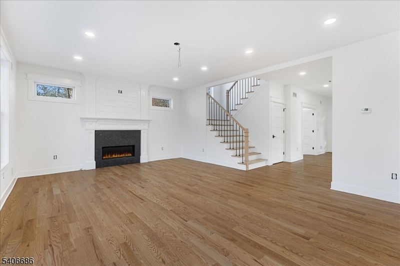 759 Mechlin Corner Road Hampton, NJ 08827 - Photo 15 of 49 an empty room with wooden floor fireplace and windows