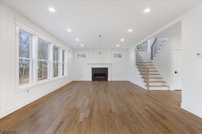 759 Mechlin Corner Road Hampton, NJ 08827 - Photo 16 of 49 a view of an empty room with wooden floor fireplace and a window
