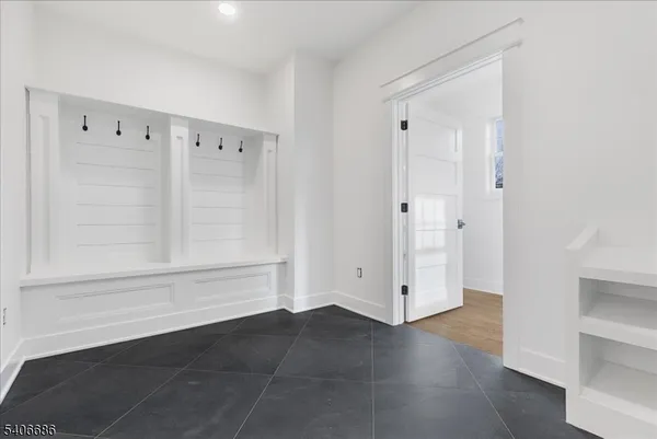 a view of a hallway with wooden floor and a cabinet