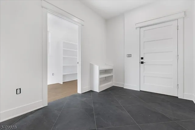 a view of a room with wooden floor and window
