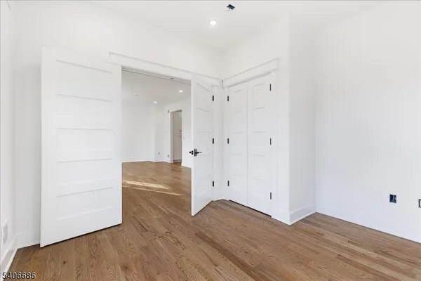 a view of an entryway with wooden floor