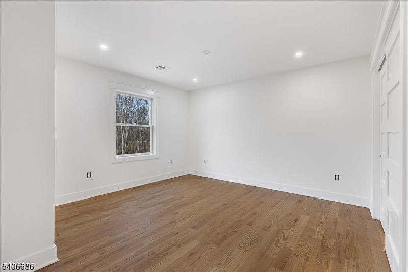 759 Mechlin Corner Road Hampton, NJ 08827 - Photo 32 of 49 an empty room with wooden floor and windows