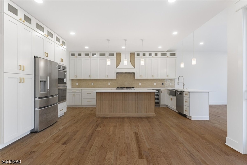 759 Mechlin Corner Road Hampton, NJ 08827 - Photo 6 of 49 a large kitchen with stainless steel appliances granite countertop a stove a refrigerator a sink and a oven with wooden floors