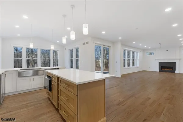 a kitchen with stainless steel appliances kitchen island a stove a refrigerator a oven and a sink