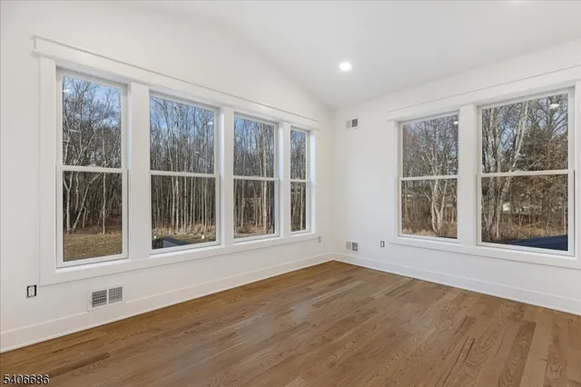 a kitchen with white cabinets and sink