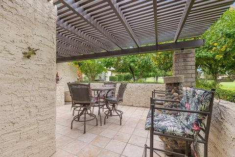 a view of a patio with table and chairs and potted plants