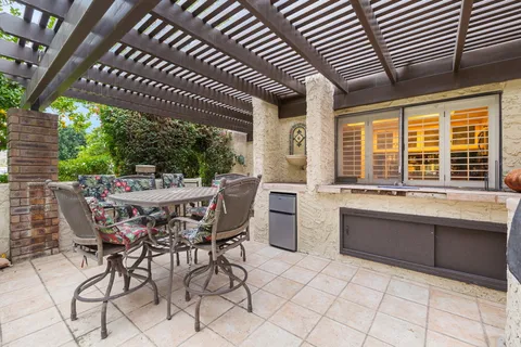 a view of a patio with table and chairs