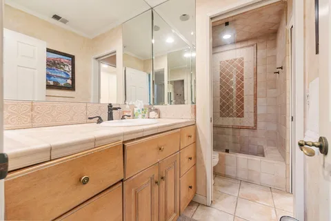 a bathroom with a shower sink and mirror