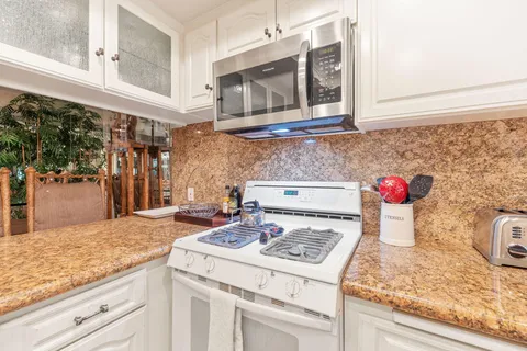 a kitchen with a stove and cabinets