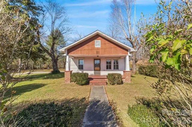 a view of a house with a yard covered in snow