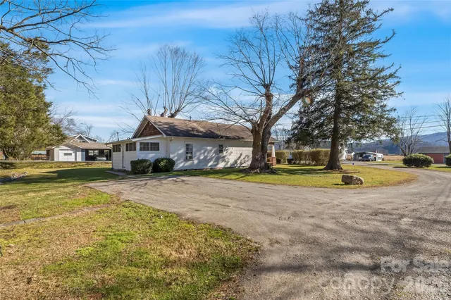 a view of a house with a yard covered in snow