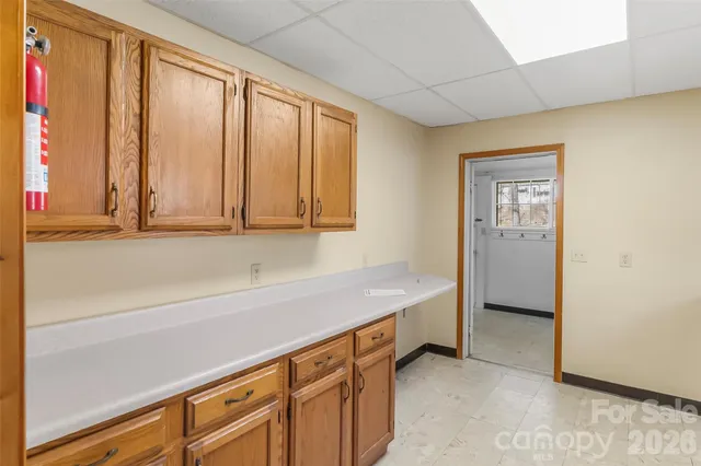 a view of a kitchen with furniture and large window