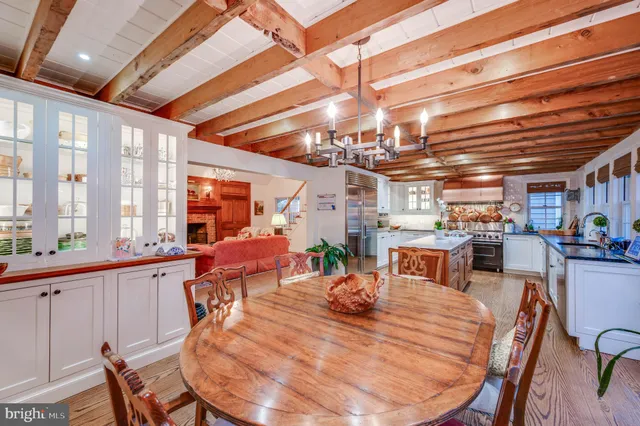 a view of a dining room with furniture large windows and wooden floor