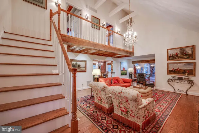 a view of a hallway with wooden floor and entryway