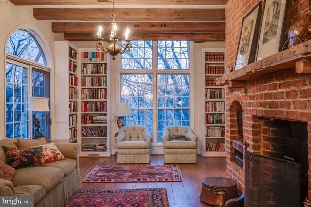 a living room with furniture a rug and a book shelf
