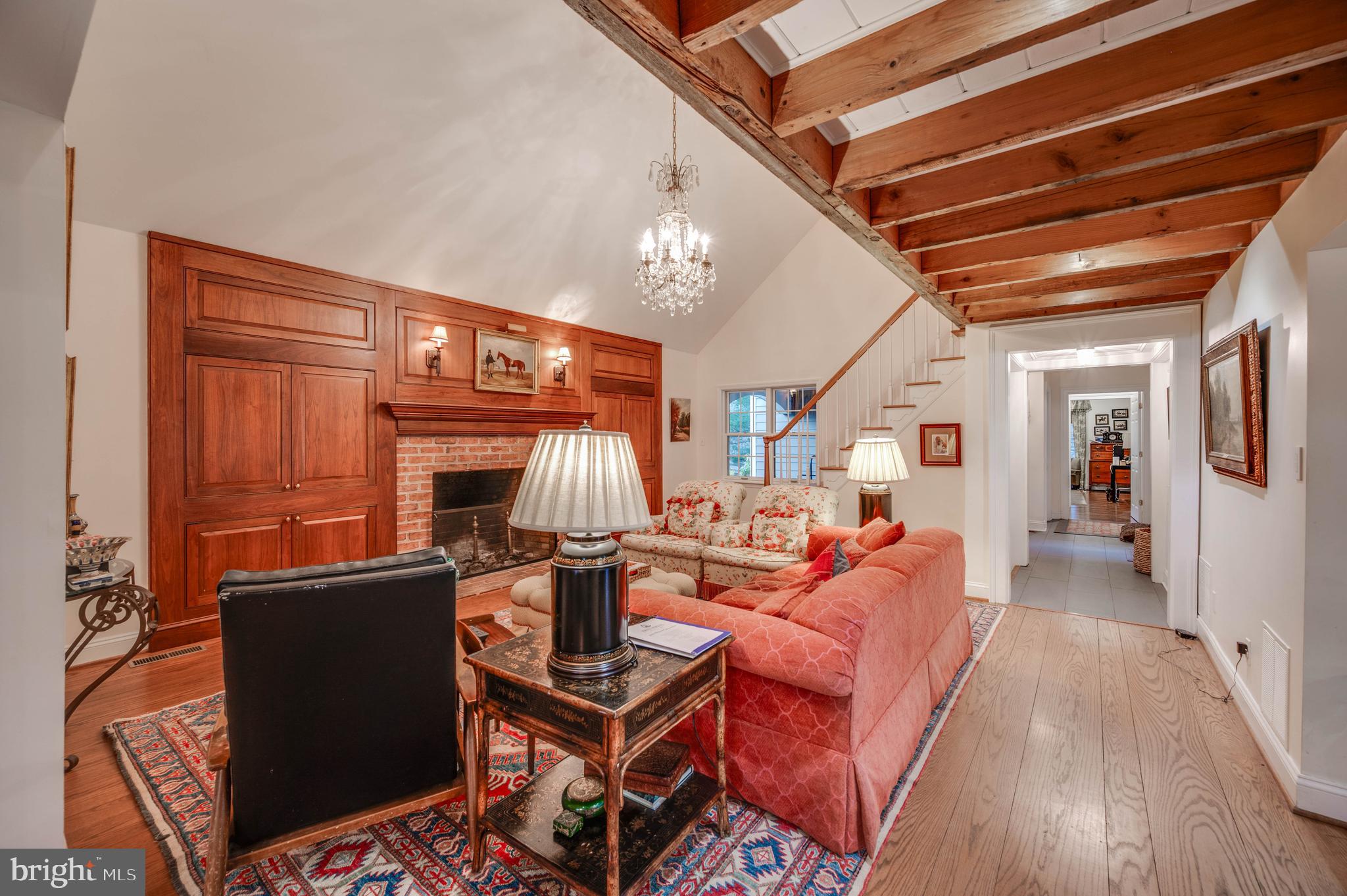 3223 Mt Zion Road Upperco, MD 21155 - Photo 59 of 65 a living room with furniture a fireplace and a chandelier