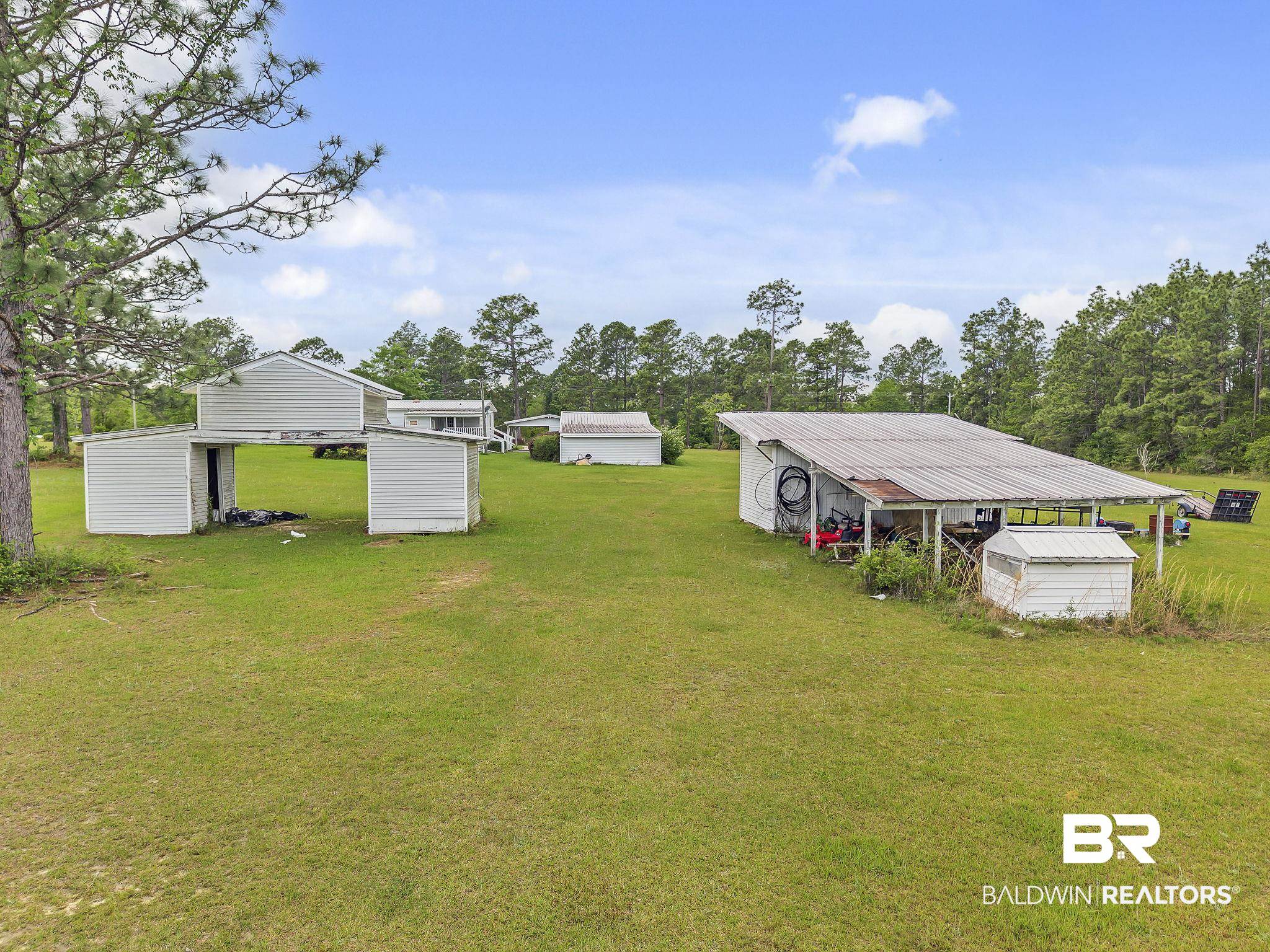 29792 County Road 65 Loxley, AL 36551 - Photo 19 of 39 View of yard featuring a storage unit, an outdoor structure, and a pole building
