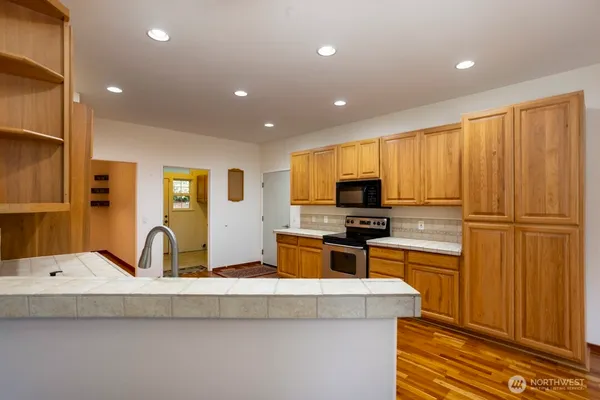 a kitchen with counter top space cabinets and stainless steel appliances