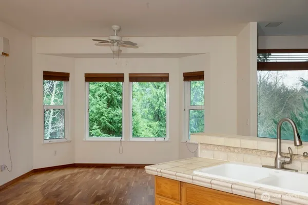 a kitchen with a sink and large window