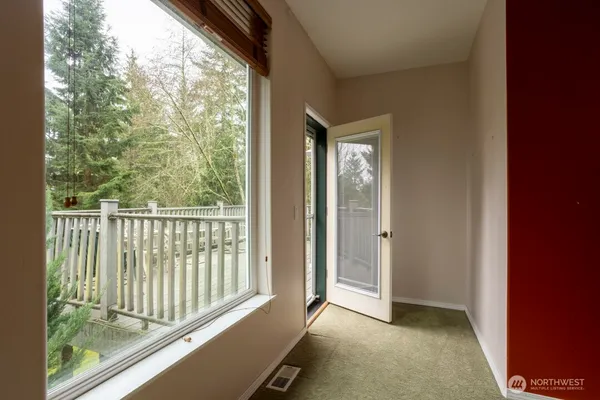 a view of a room with wooden floor and windows
