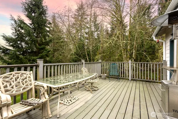 a view of balcony with wooden floor and fence