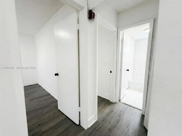 a view of a hallway with wooden floor
