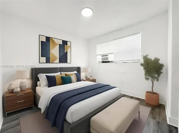 a bedroom with a bed and a potted plant