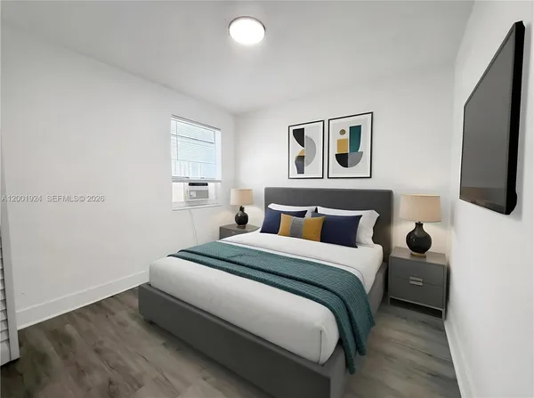 a bedroom with a bed and a flat screen tv