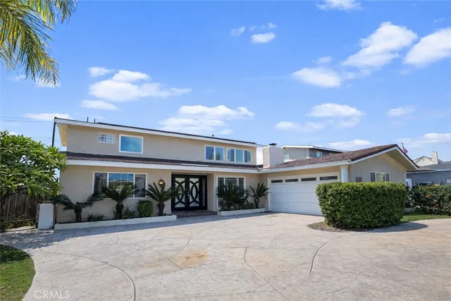 a view of a house with a yard and potted plants