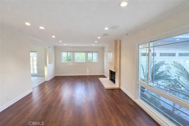 a view of wooden floor and windows in an empty room