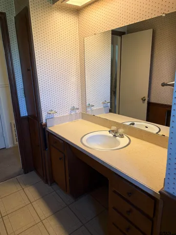 a bathroom with a sink and a mirror