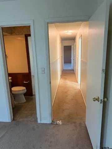 a view of a bathroom from a hallway