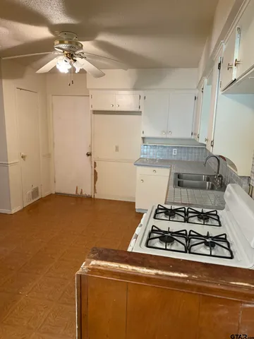 a utility room with stove cabinets and a kitchen