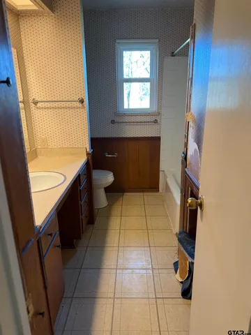 a bathroom with a sink a toilet and a bathtub