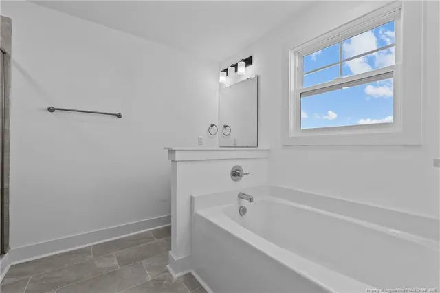 a bathroom with a shower and a glass door