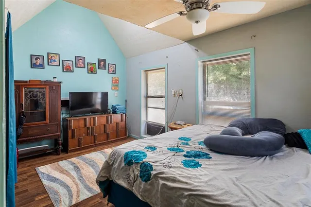 a bedroom with a bed and a television